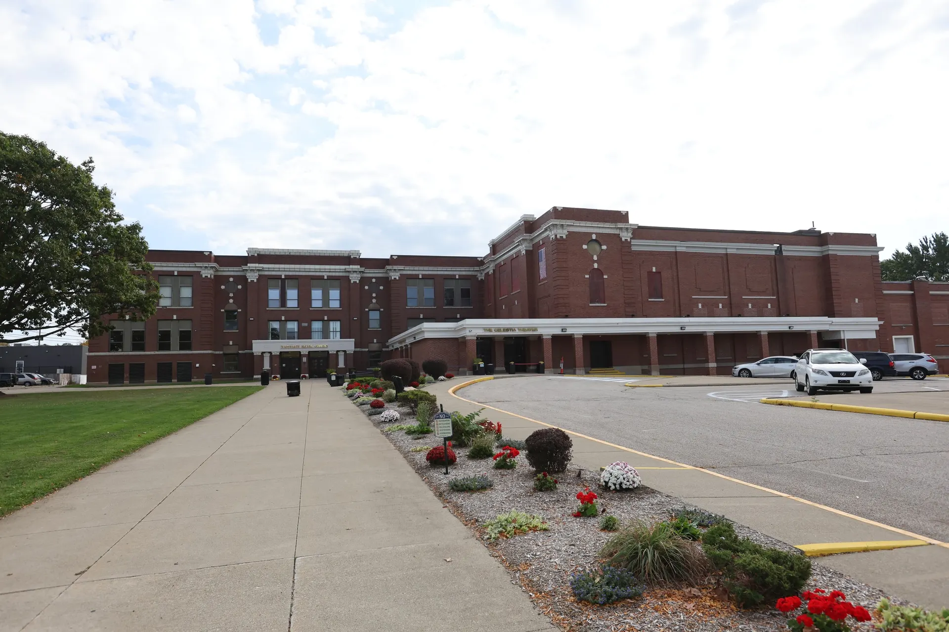 A wide view of the Central School facade and the covered Celestia Theater entrance from the front walk