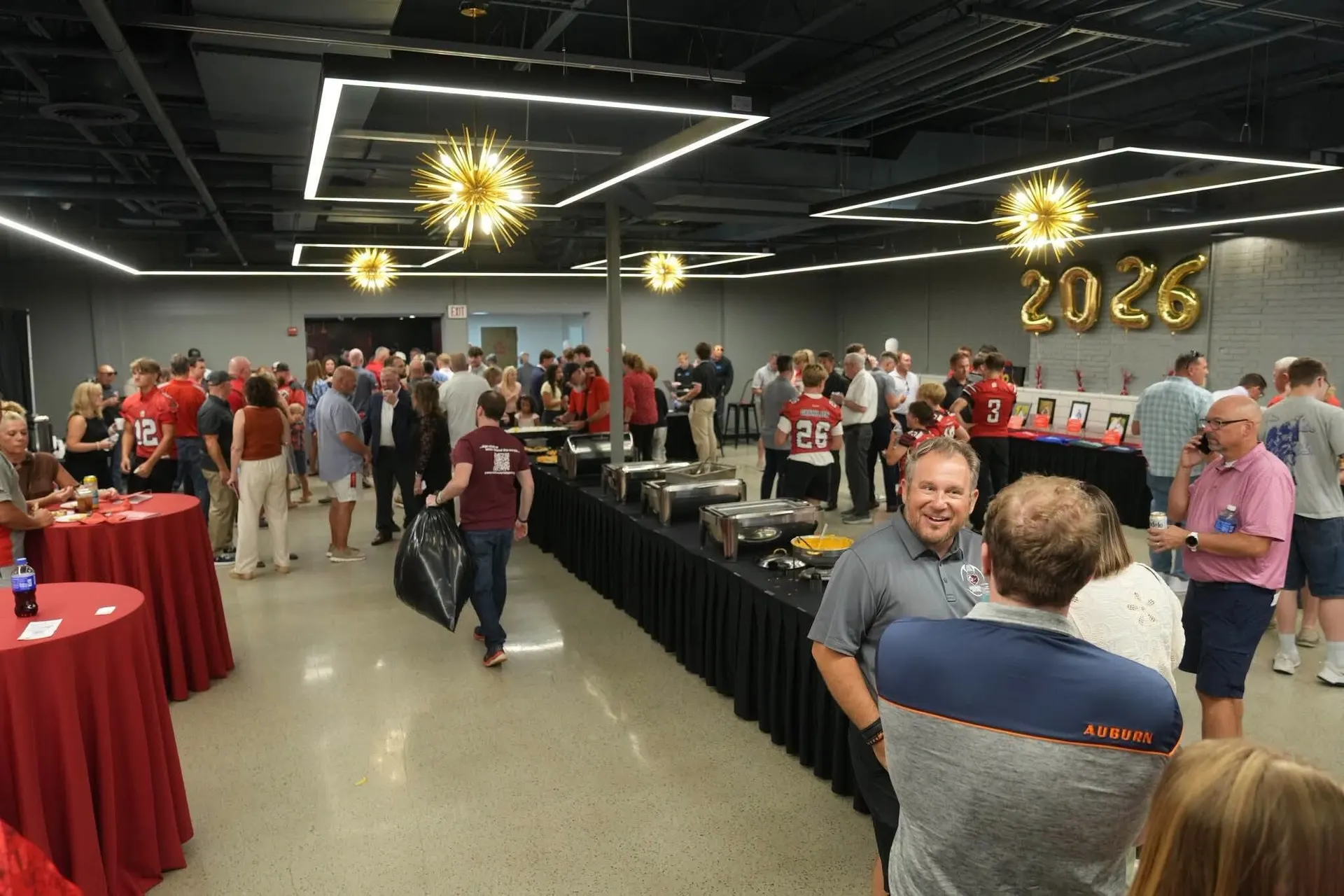 A reception in the Event Center with buffet tables, balloons and a 2026 sign