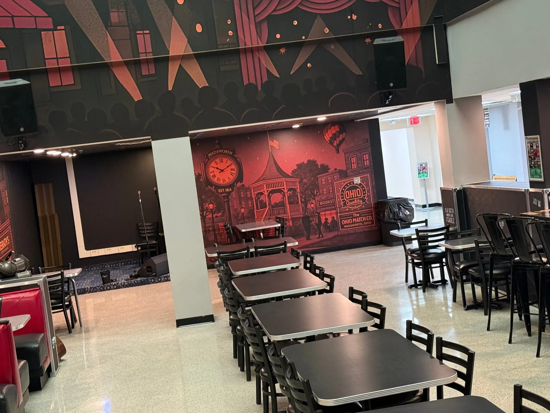 Tables and chairs in the Flame dining room with the downtown Wadsworth mural on the far wall