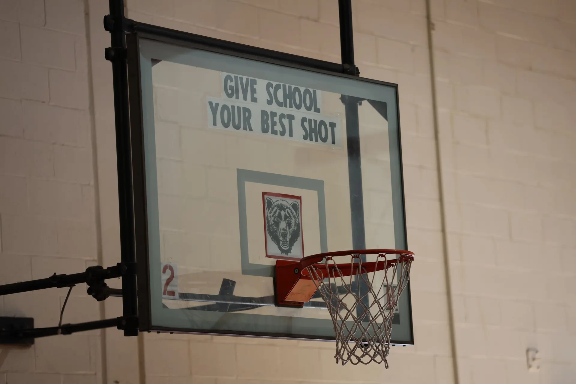A gym backboard reading Give School Your Best Shot with the Wadsworth Grizzly